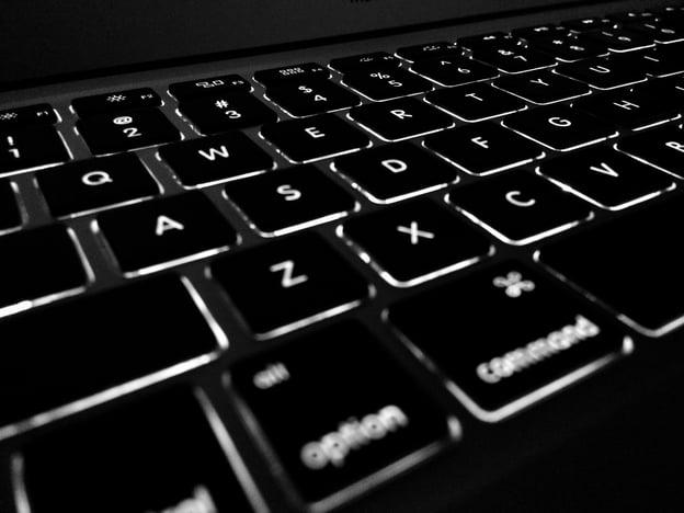 An illuminated black computer keyboard.